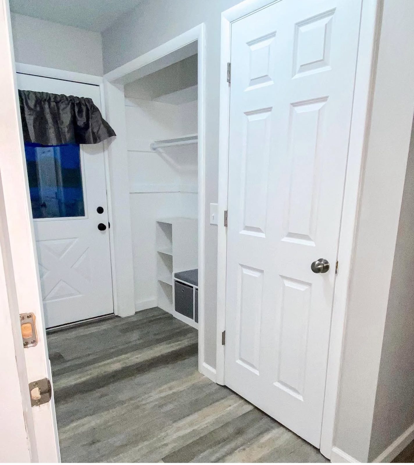 After photo of remodeled breezeway in Grand Rapids with white trim, wall detail, and updated flooring