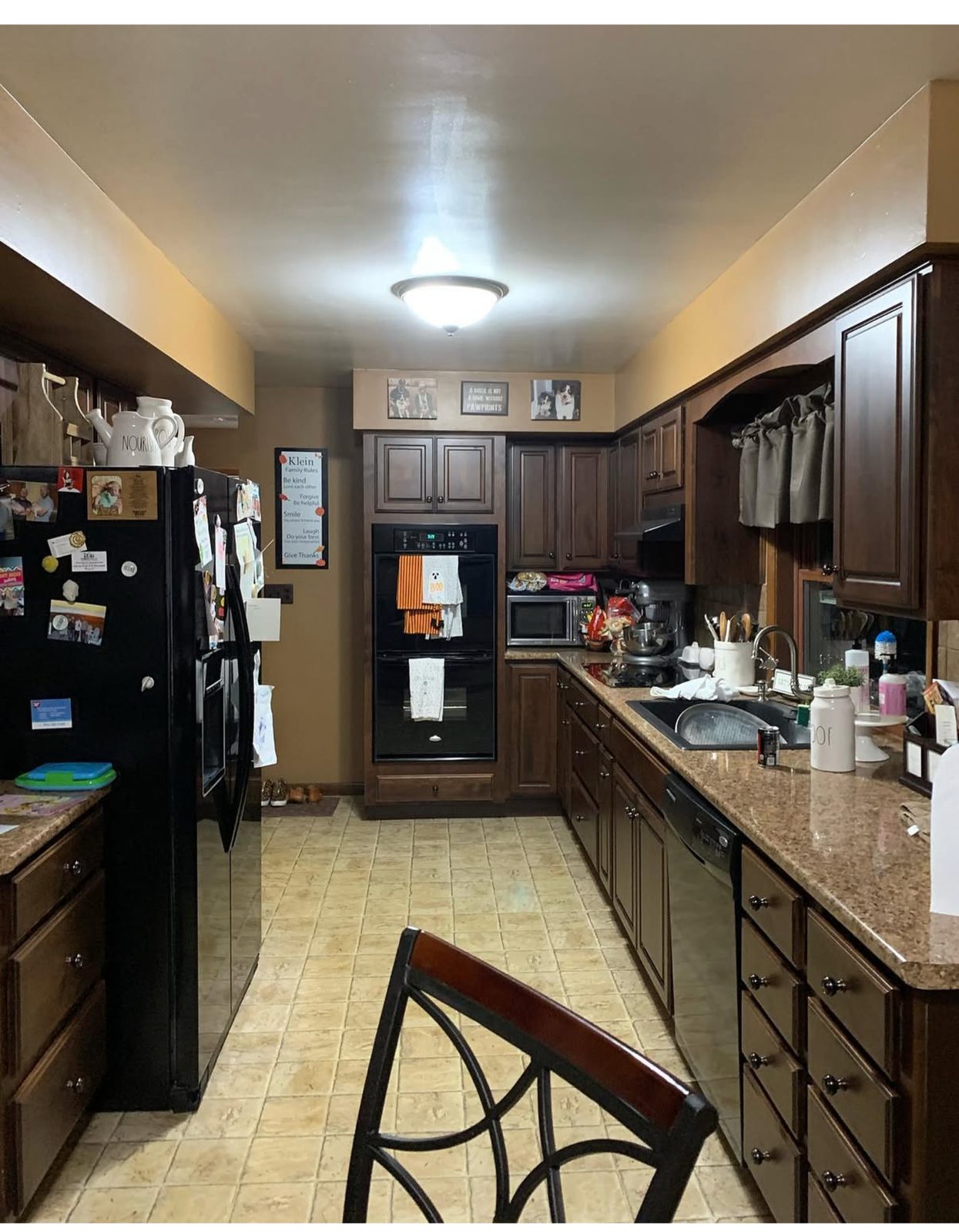 Before angle of second Grand Rapids kitchen remodel with peninsula and bar stools